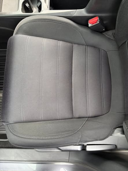 Close view of a clean dark cloth vehicle seat