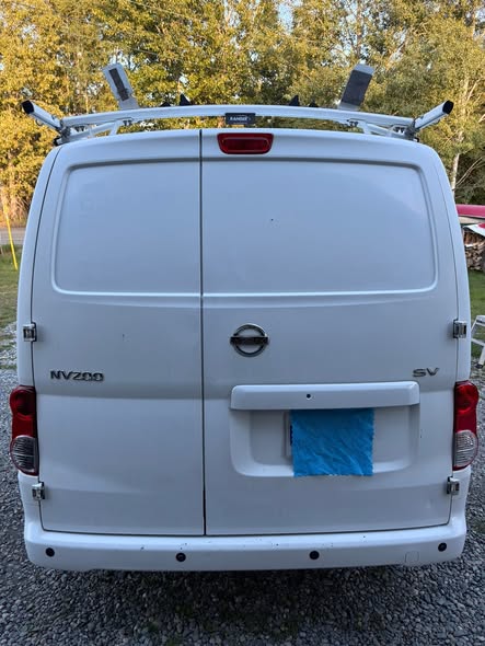 Rear of a white work van with clean exterior panels